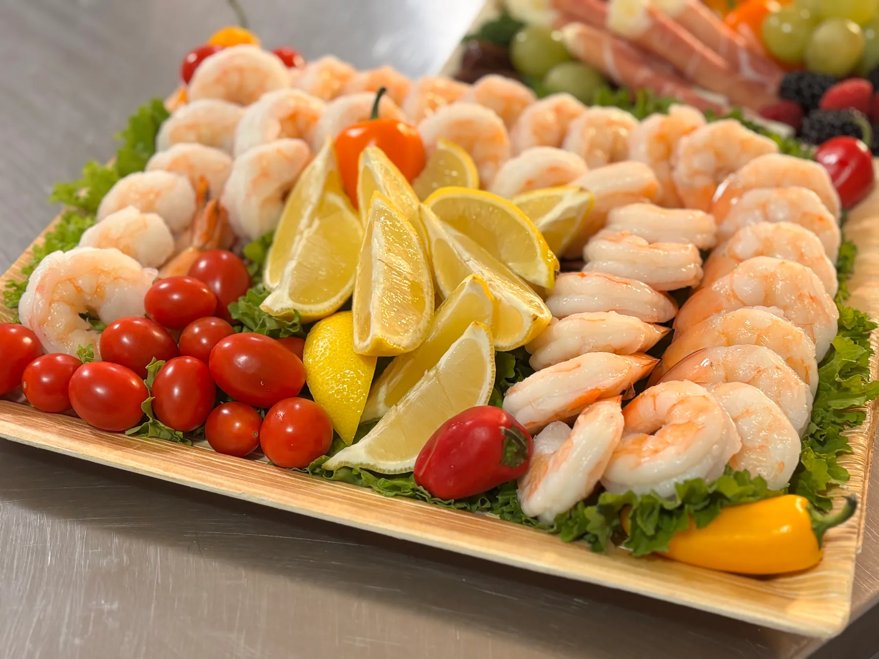 A shrimp platter with fresh lemon and cocktail sauce