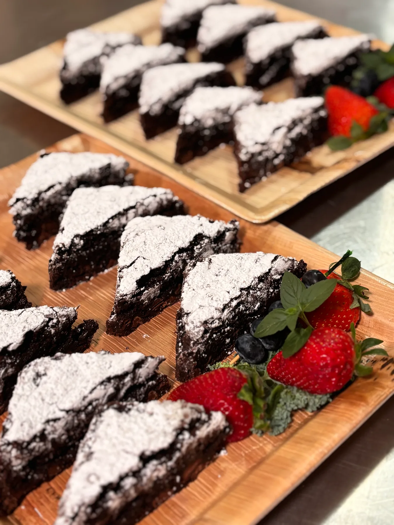 Chocolate cake slices served with fresh strawberries
